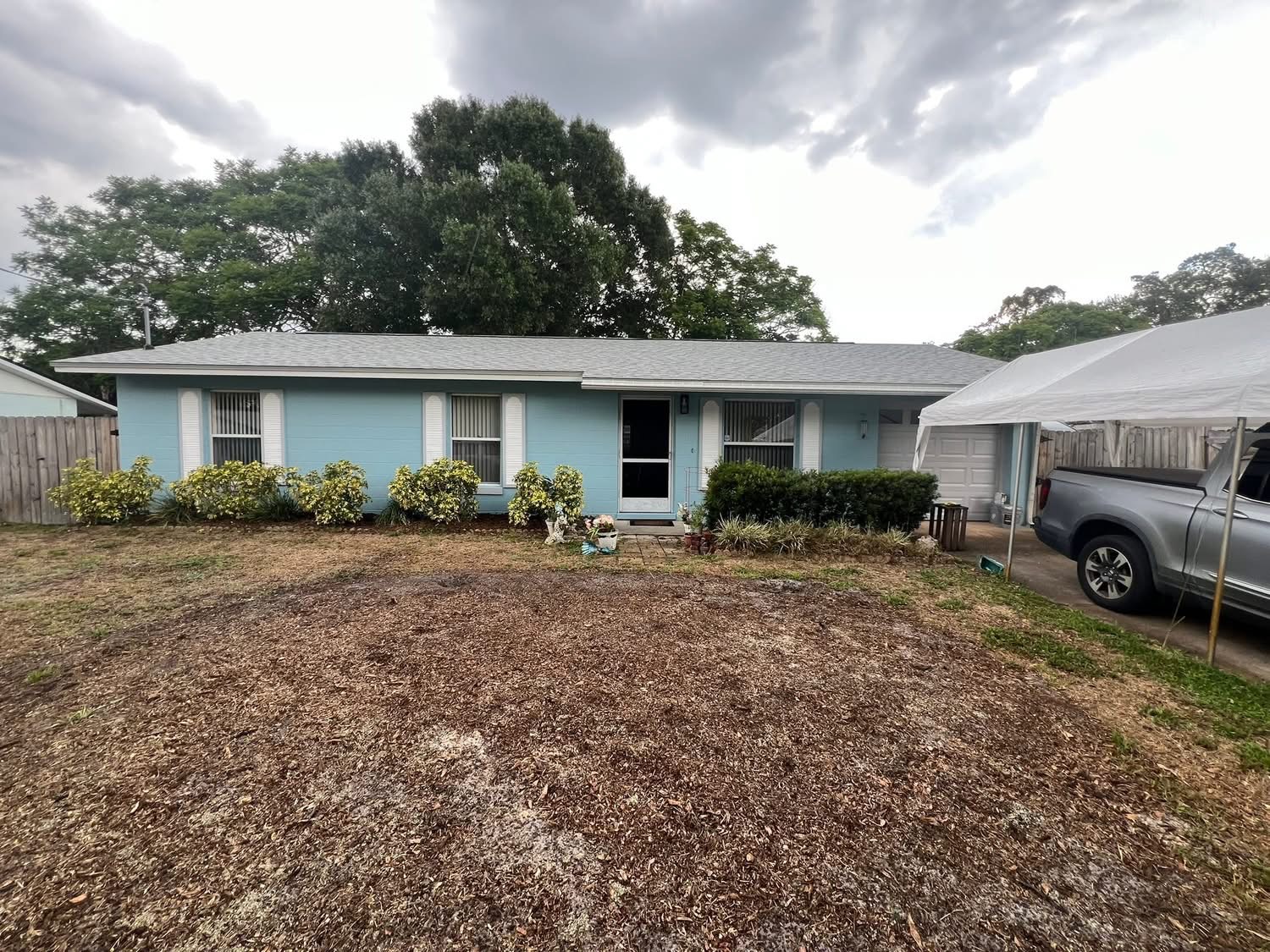 Same home with light blue siding and white trim after painting