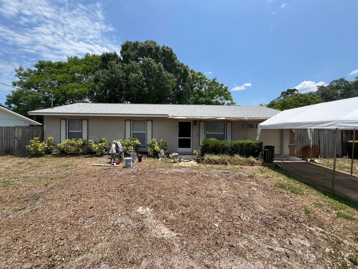 Single-story tan home before exterior color change